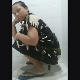 An Indonesian girl shits into a floor toilet and is viewed from a nice side perspective with visible poop action beneath her ass. She holds her nose because of the smell. Vertical format video. About 3.5 minutes.